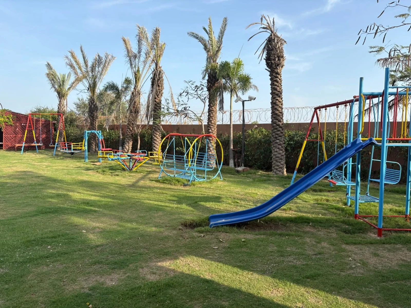 Kids play area with swings and slide on the lawn